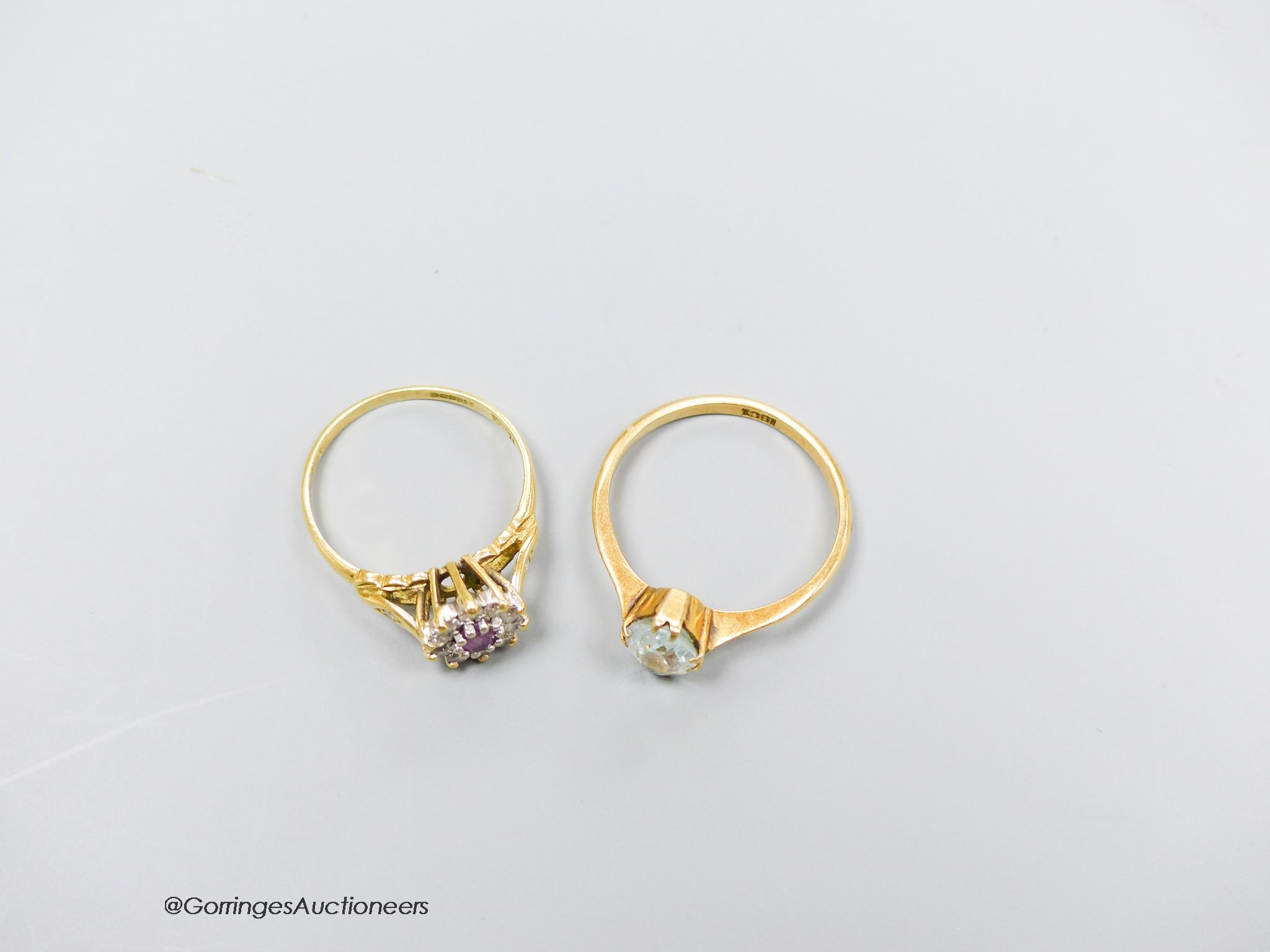 An 18ct gold diamond and pink stone cluster ring, size K and an 18ct gold and aquamarine ring, size M. Gross 4g.